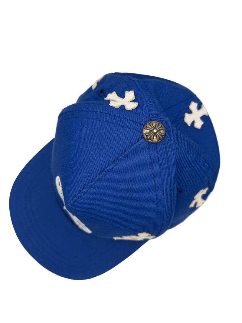 Blue cap with white patterns on a white surface